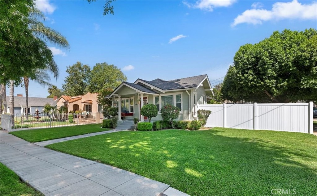 3398 Locust Street Riverside, CA 92501 - Photo 4 of 33 a front view of a house with a yard and trees