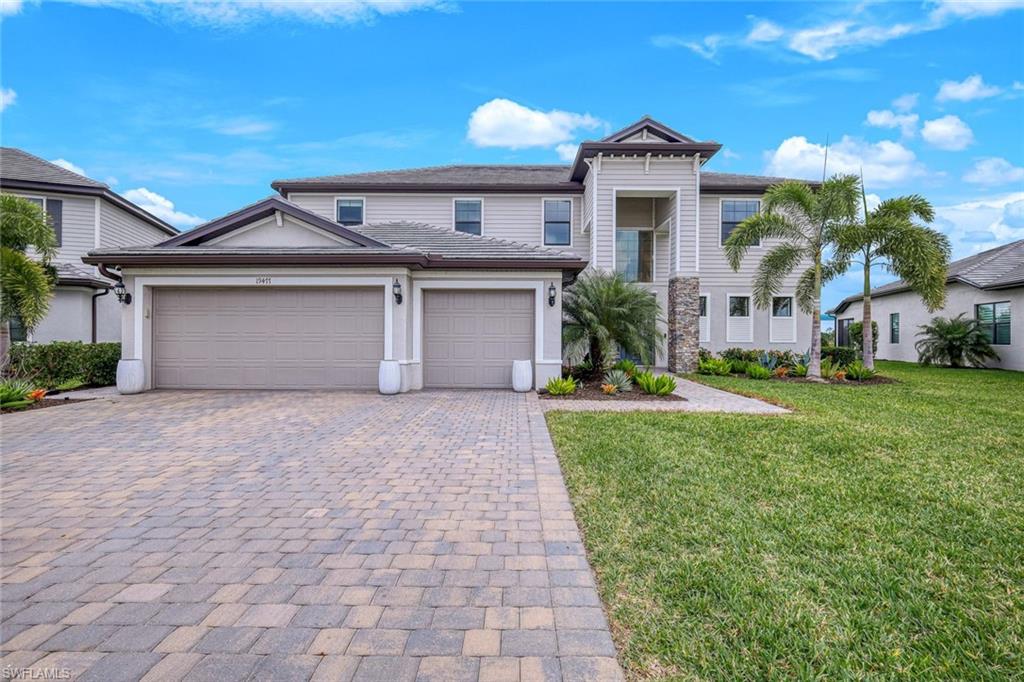 a front view of a house with a yard and garage