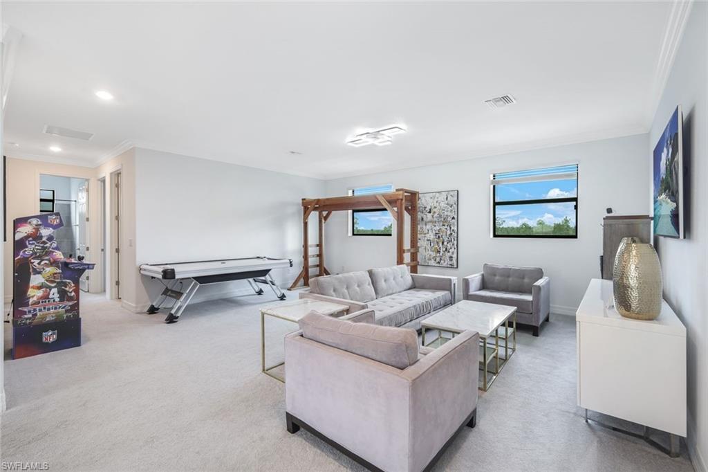 19477 The Pl Boulevard Estero, FL 33928 - Photo 19 of 36 a living room with furniture and a flat screen tv