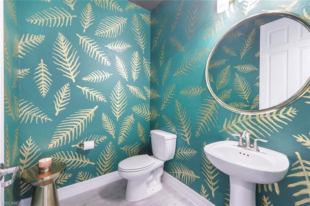 19477 The Pl Boulevard Estero, FL 33928 - Photo 20 of 36 a bathroom with a sink and mirror