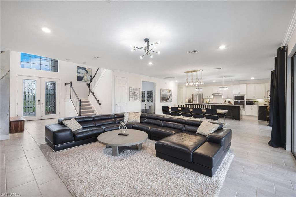 19477 The Pl Boulevard Estero, FL 33928 - Photo 2 of 36 a living room with furniture and a large window