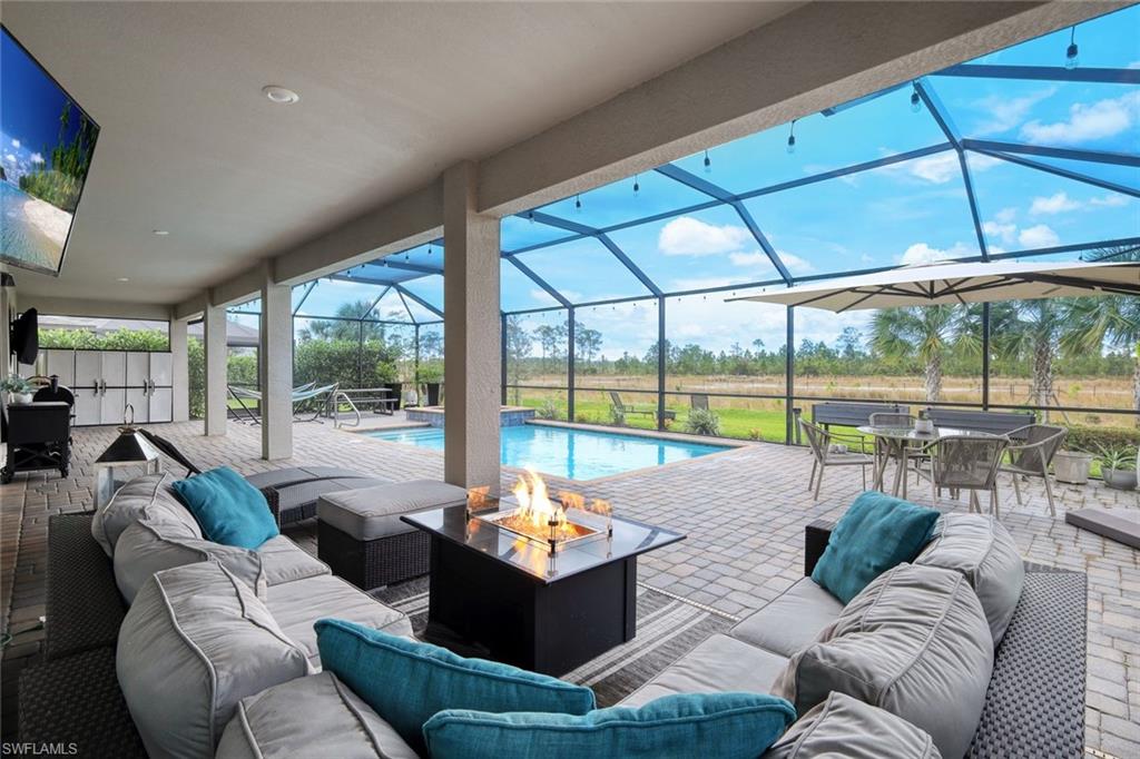 19477 The Pl Boulevard Estero, FL 33928 - Photo 23 of 36 a living room with furniture and a floor to ceiling window