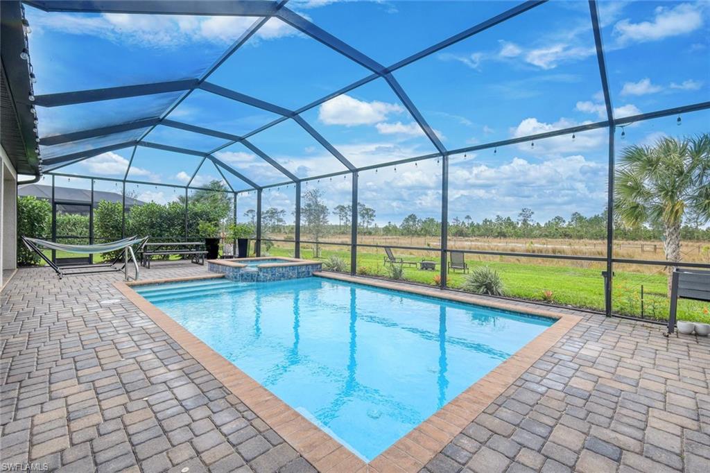 19477 The Pl Boulevard Estero, FL 33928 - Photo 24 of 36 a view of a swimming pool with a porch