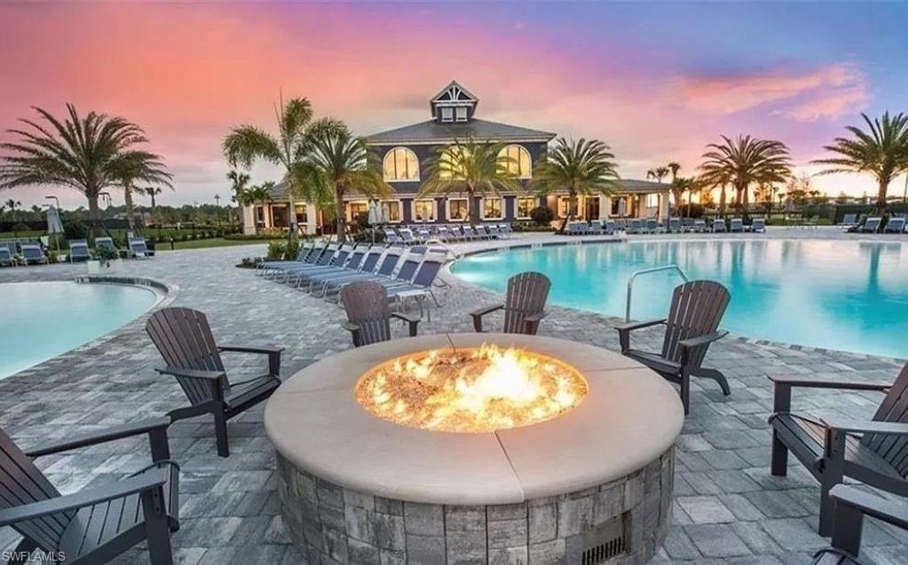 19477 The Pl Boulevard Estero, FL 33928 - Photo 29 of 36 a view of a swimming pool with outdoor seating and plants