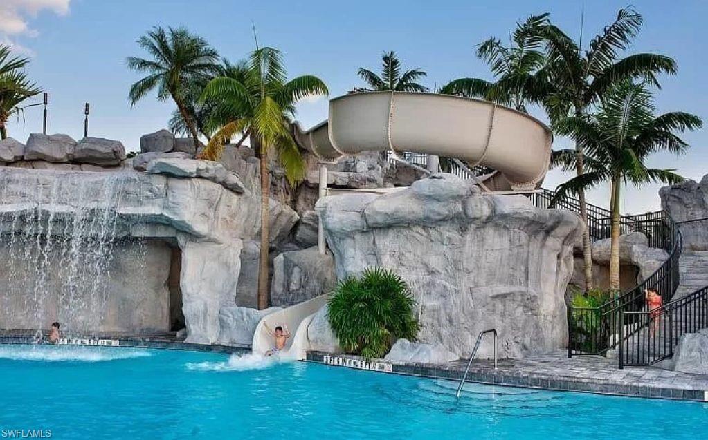 19477 The Pl Boulevard Estero, FL 33928 - Photo 36 of 36 a palm tree sitting in front of a house with a yard
