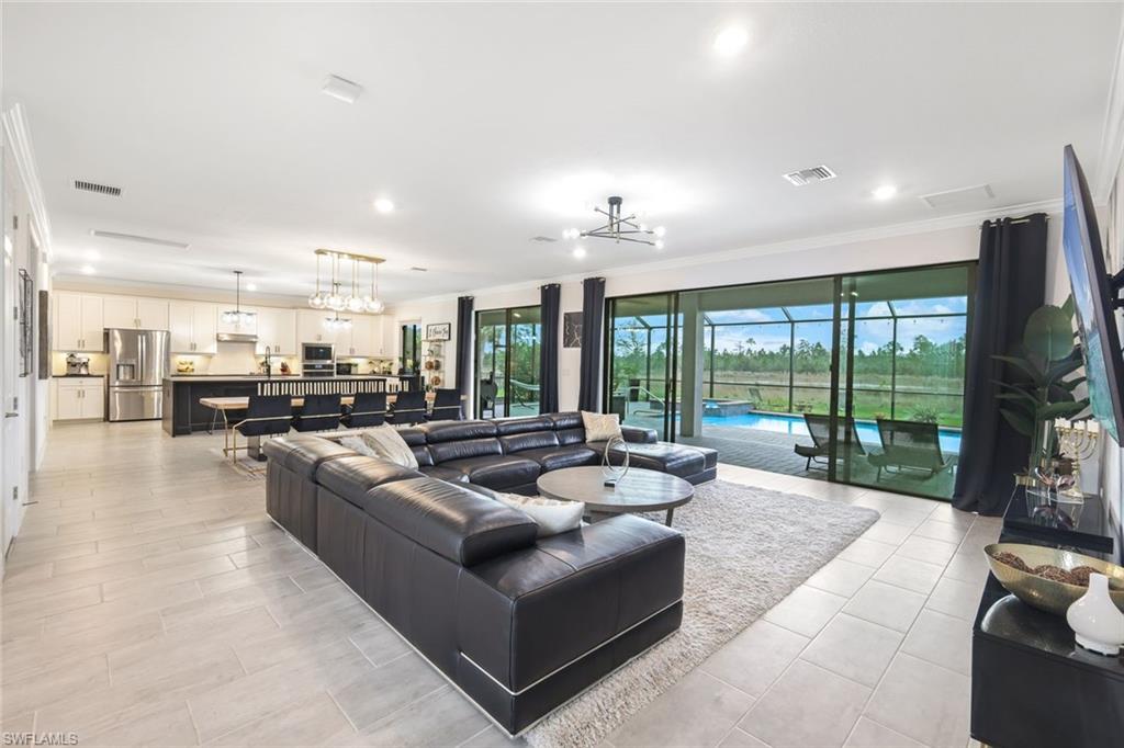 19477 The Pl Boulevard Estero, FL 33928 - Photo 8 of 36 a living room with furniture kitchen view and a large window