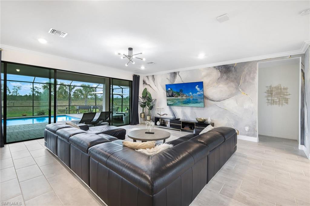19477 The Pl Boulevard Estero, FL 33928 - Photo 9 of 36 a living room with furniture and a large window
