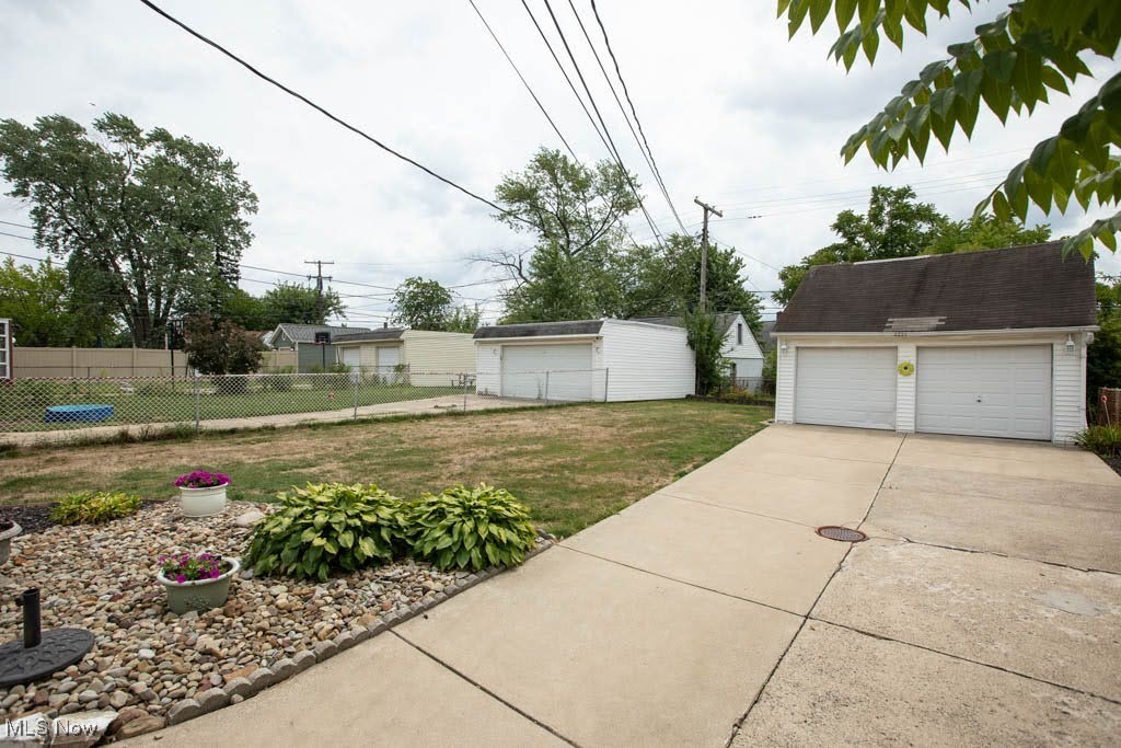 12822 Grannis Road Cleveland, OH 44125 - Photo 34 of 44 View of yard featuring a garage and an outdoor structure
