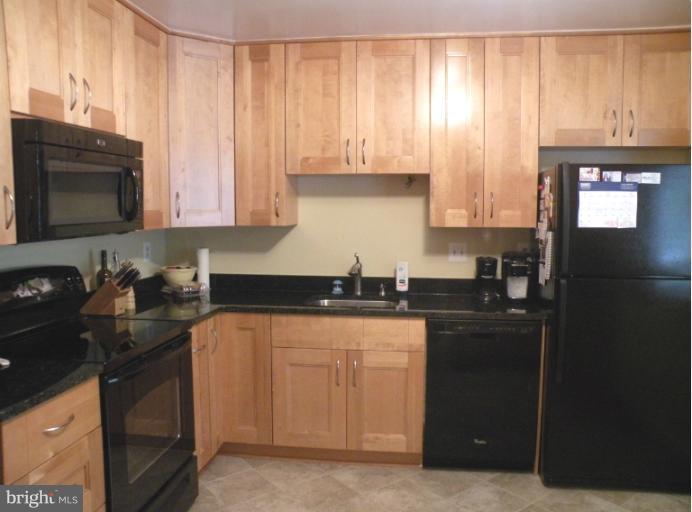 1721 Logmill Lane Gaithersburg, MD 20879 - Photo 2 of 16 a kitchen with granite countertop a stove sink and cabinets