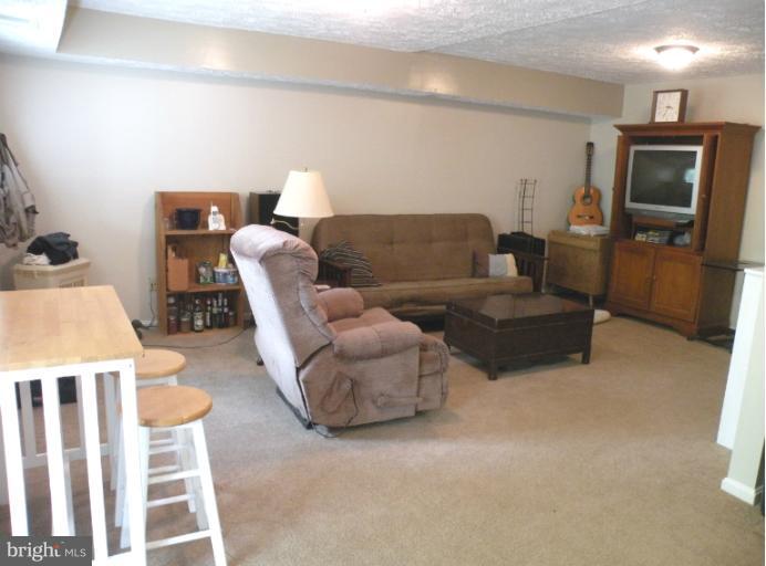 1721 Logmill Lane Gaithersburg, MD 20879 - Photo 4 of 16 a living room with furniture and a flat screen tv