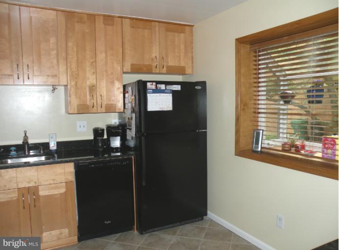 1721 Logmill Lane Gaithersburg, MD 20879 - Photo 6 of 16 a kitchen with granite countertop cabinets and black appliances