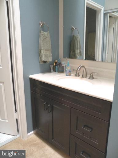 1721 Logmill Lane Gaithersburg, MD 20879 - Photo 7 of 16 a bathroom with a sink vanity and a mirror