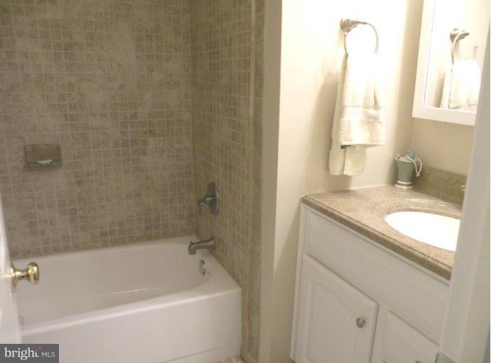 1721 Logmill Lane Gaithersburg, MD 20879 - Photo 9 of 16 a bathroom with a granite countertop sink toilet and bathtub