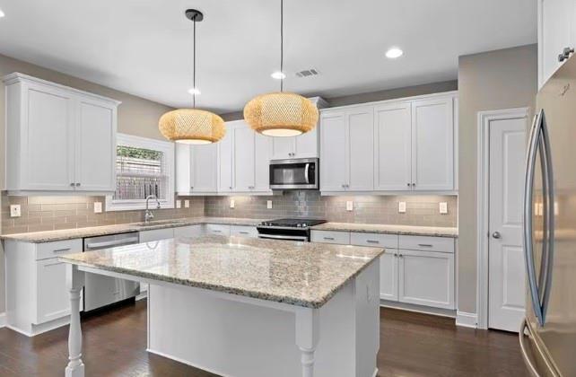1063 Johnson Grove Atlanta, GA 30318 - Photo 11 of 23 a kitchen with stainless steel appliances granite countertop a sink a stove and a refrigerator
