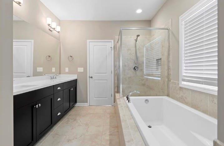 1063 Johnson Grove Atlanta, GA 30318 - Photo 15 of 23 a spacious bathroom with a tub sink shower and mirror