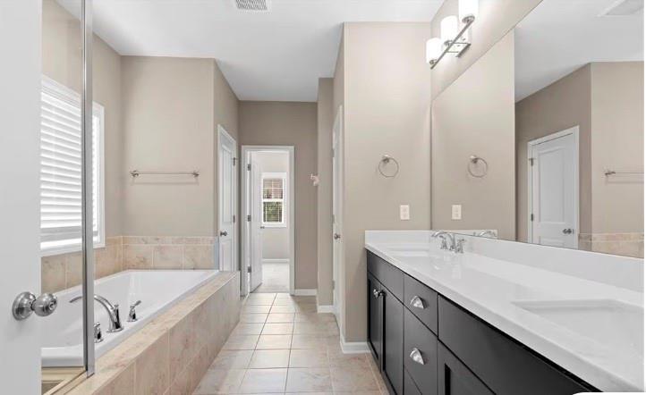 1063 Johnson Grove Atlanta, GA 30318 - Photo 16 of 23 a spacious bathroom with a tub sink shower and mirror