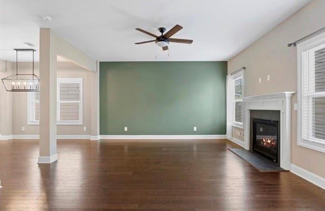 1063 Johnson Grove Atlanta, GA 30318 - Photo 5 of 23 a view of a livingroom with a fireplace a ceiling fan and a kitchen view