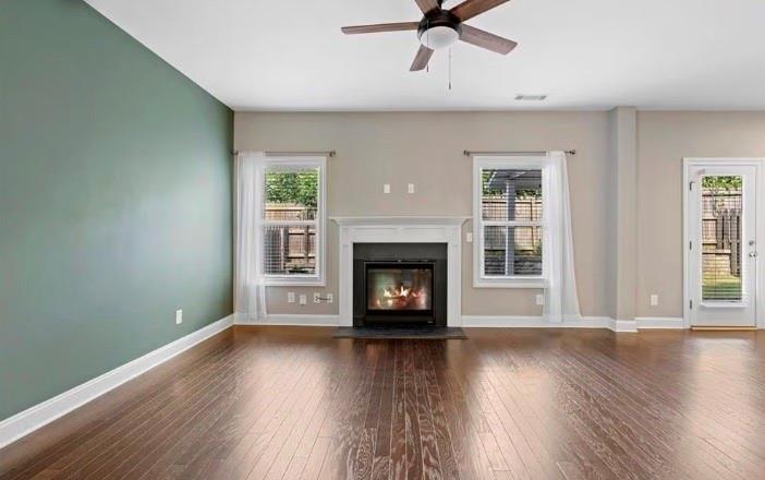 1063 Johnson Grove Atlanta, GA 30318 - Photo 7 of 23 an empty room with wooden floor a fireplace and windows