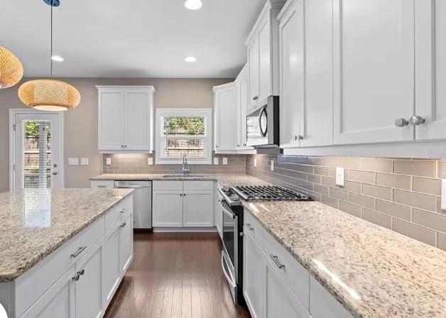 1063 Johnson Grove Atlanta, GA 30318 - Photo 9 of 23 a kitchen with granite countertop cabinets a sink a window and stainless steel appliances