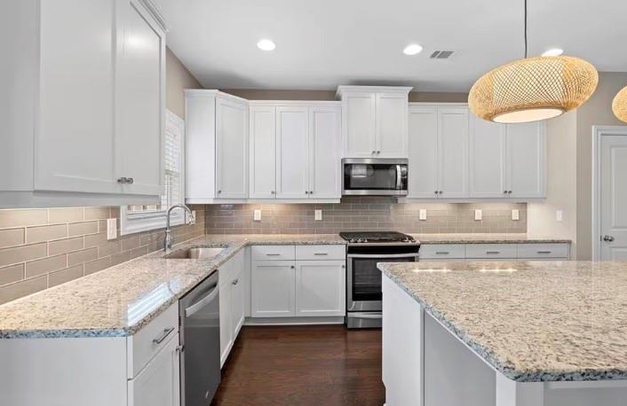 1063 Johnson Grove Atlanta, GA 30318 - Photo 10 of 23 a kitchen with stainless steel appliances granite countertop a sink stove and microwave