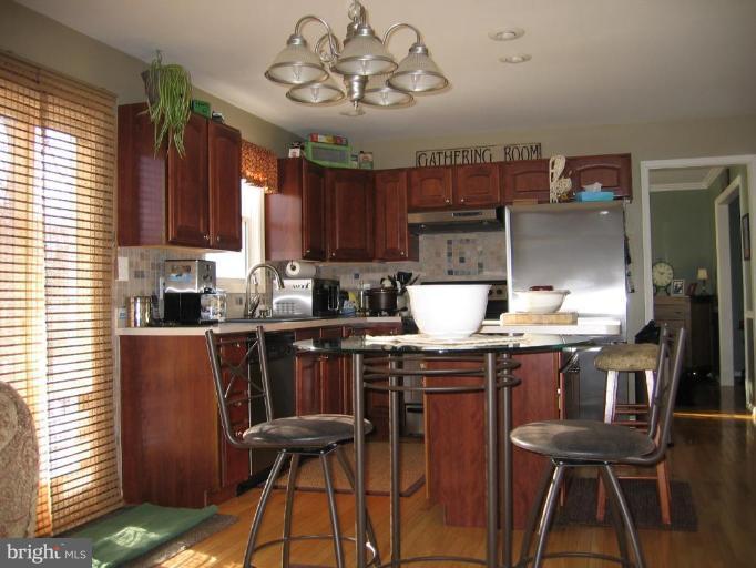 2511 Fairmount Road Hampstead, MD 21074 - Photo 2 of 30 a kitchen with cabinets appliances and a dining table
