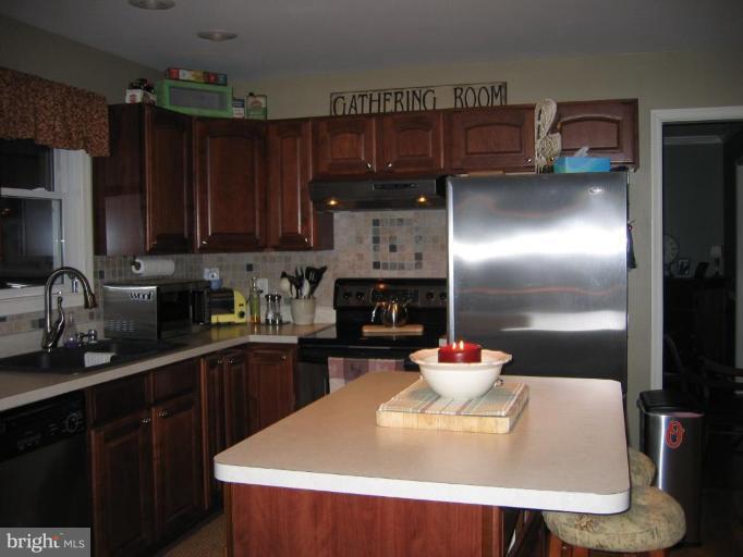 2511 Fairmount Road Hampstead, MD 21074 - Photo 24 of 30 a kitchen with a refrigerator and a sink