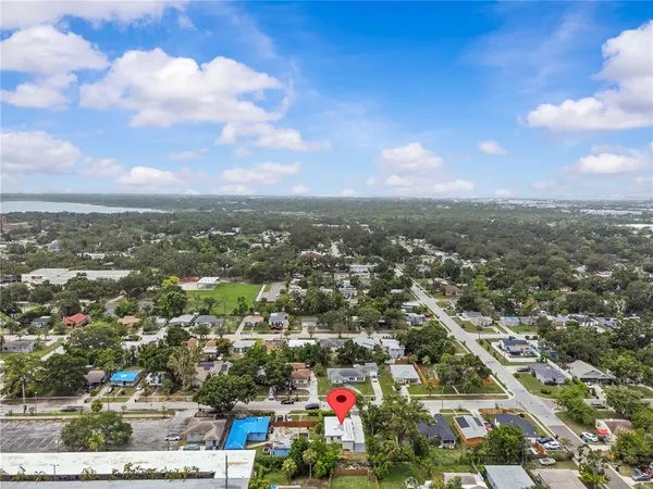 an aerial view of residential houses with city view