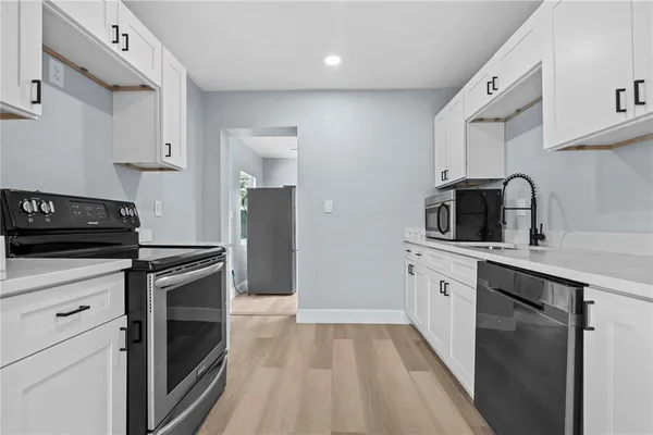 a kitchen with a sink stove and refrigerator