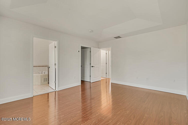19 Russell Court Matawan, NJ 07747 - Photo 16 of 29 a view of an empty room with wooden floor and window