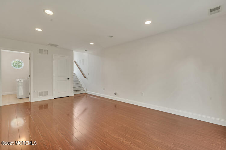 19 Russell Court Matawan, NJ 07747 - Photo 20 of 29 an empty room with wooden floor and windows