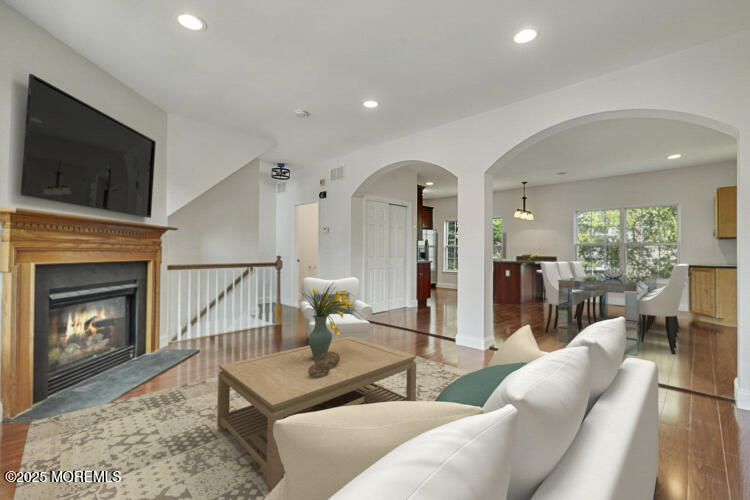 19 Russell Court Matawan, NJ 07747 - Photo 5 of 29 a living room with furniture a flat screen tv and a fireplace