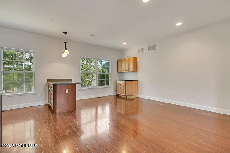 19 Russell Court Matawan, NJ 07747 - Photo 8 of 29 a view of empty room with wooden floor and fan