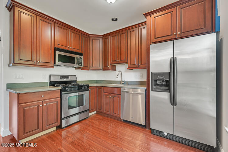 19 Russell Court Matawan, NJ 07747 - Photo 9 of 29 a kitchen with stainless steel appliances granite countertop a refrigerator stove top oven and sink