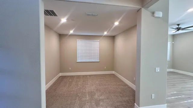 an empty room with windows and closet