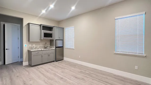 a kitchen with a sink stove and refrigerator