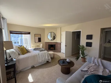 a bedroom with furniture and a fireplace