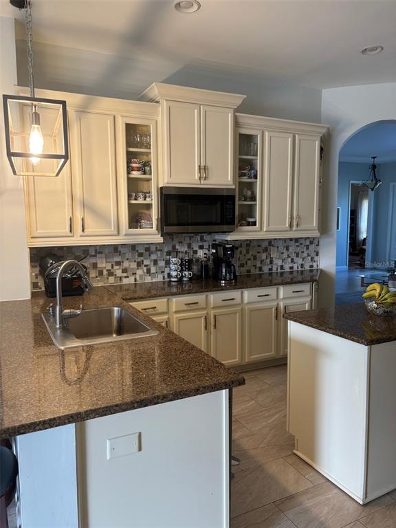 20104 Pond Spring Way Tampa, FL 33647 - Photo 15 of 51 a kitchen with granite countertop a sink a stove and cabinets