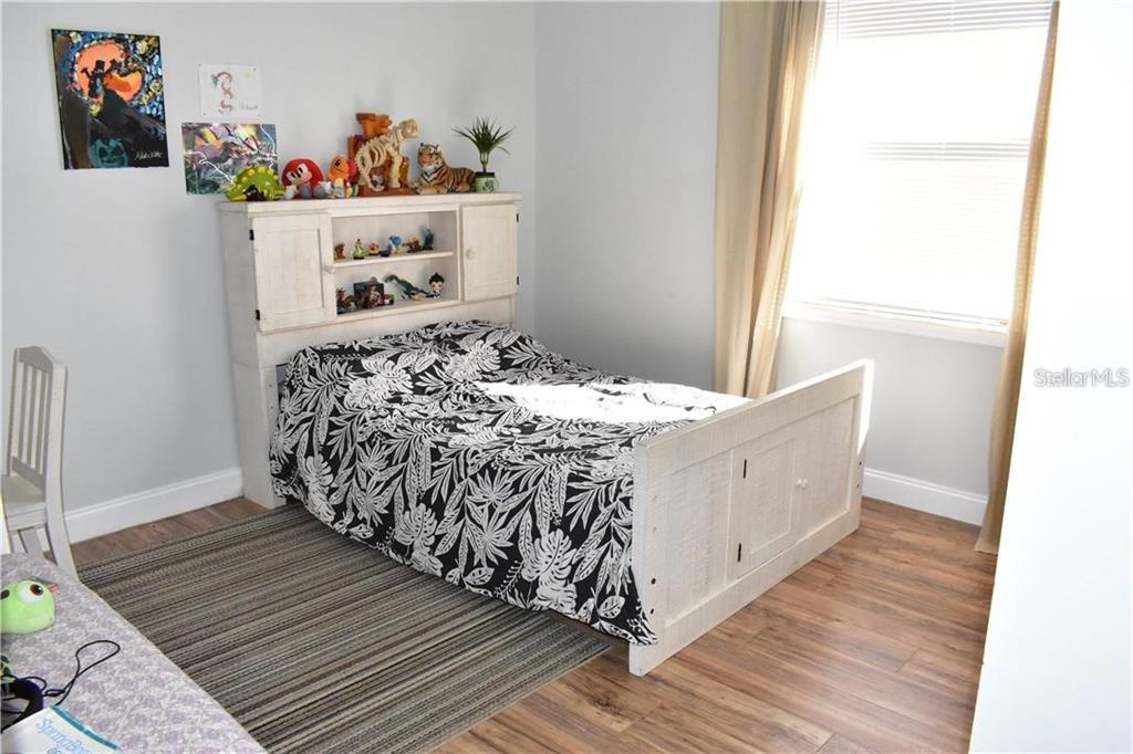 20104 Pond Spring Way Tampa, FL 33647 - Photo 18 of 51 a room with a bed and wooden floor