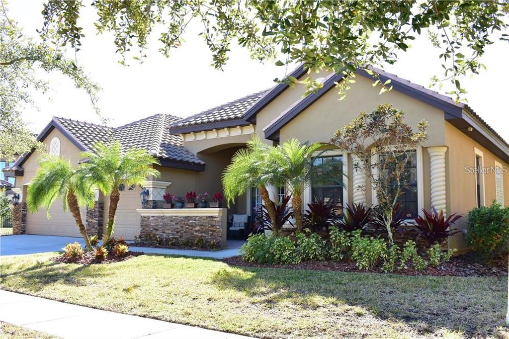 20104 Pond Spring Way Tampa, FL 33647 - Photo 2 of 51 a front view of house with yard