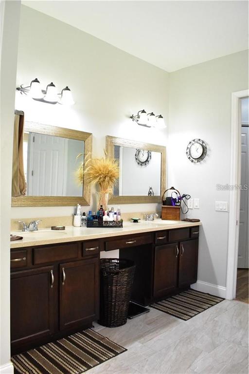 20104 Pond Spring Way Tampa, FL 33647 - Photo 21 of 51 a bathroom with a sink and a mirror