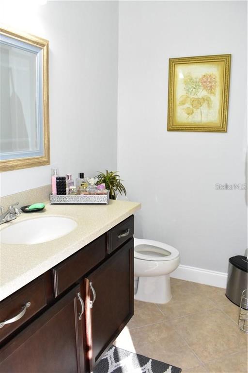 20104 Pond Spring Way Tampa, FL 33647 - Photo 26 of 51 a bathroom with a sink a toilet and mirror