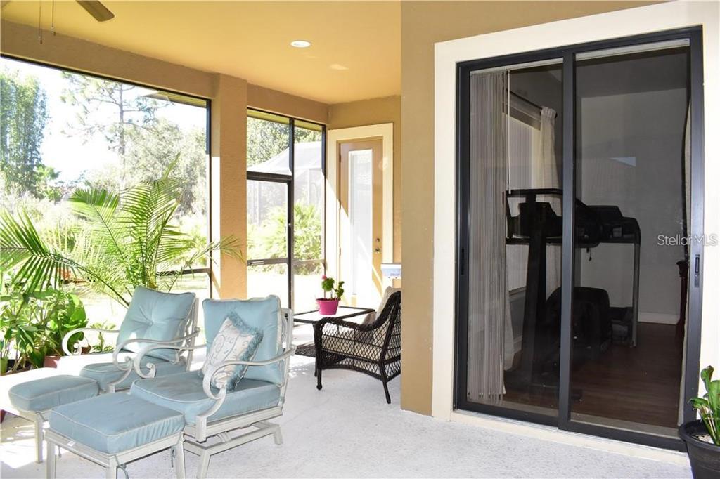 20104 Pond Spring Way Tampa, FL 33647 - Photo 28 of 51 a living room with furniture and a floor to ceiling window