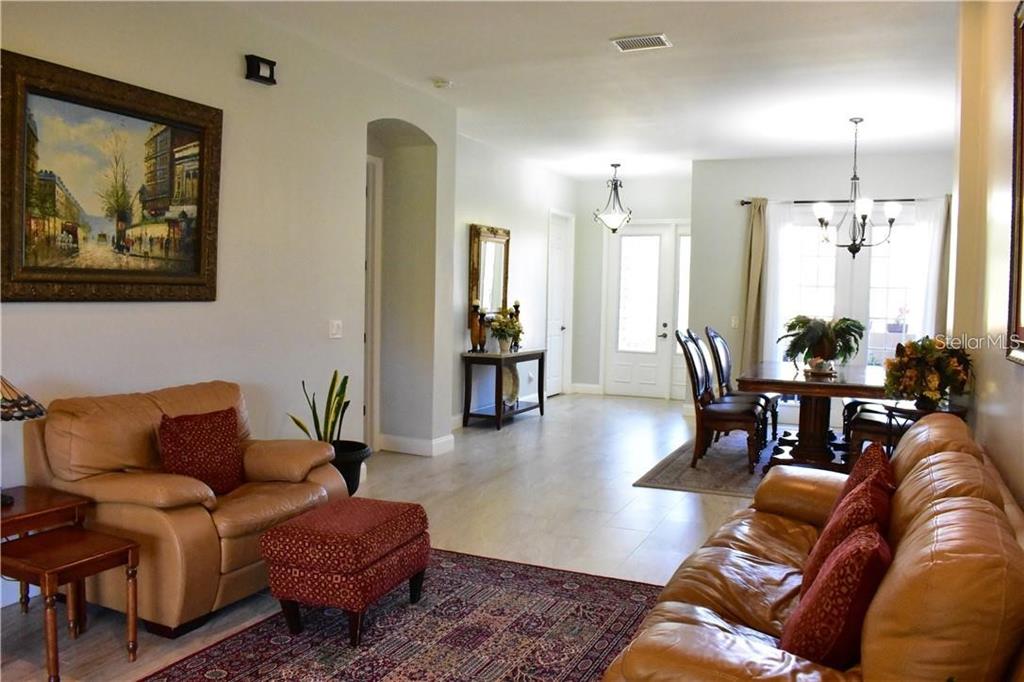20104 Pond Spring Way Tampa, FL 33647 - Photo 8 of 51 a living room with furniture and wooden floor