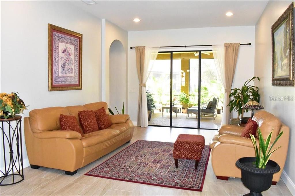 20104 Pond Spring Way Tampa, FL 33647 - Photo 9 of 51 a living room with furniture potted plant and a window