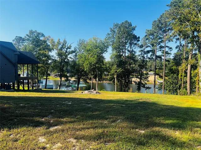 a view of a swimming pool in a yard with lawn chairs