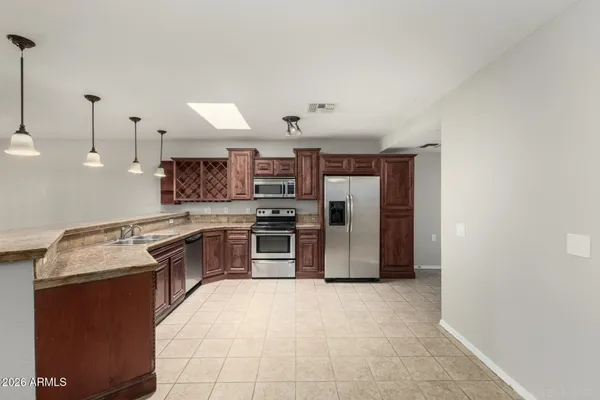 a kitchen with stainless steel appliances granite countertop a sink and stove