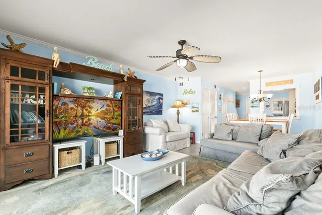 a living room with furniture and a chandelier