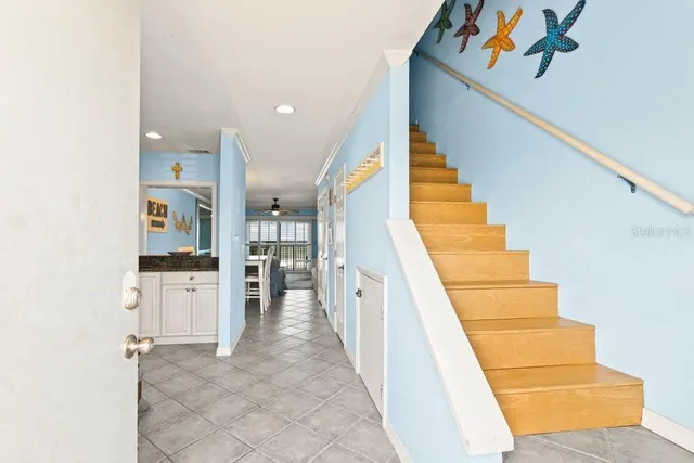 a view of a kitchen with furniture and staircase
