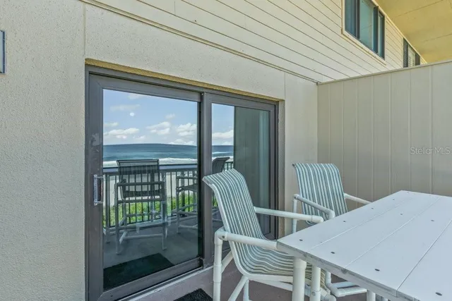 a view of a balcony with furniture