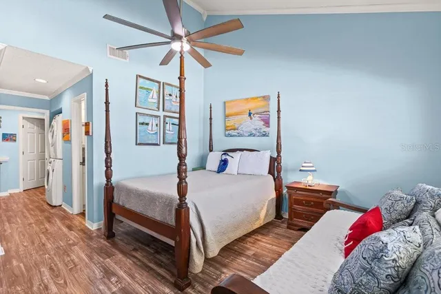 a bedroom with a large bed and a window